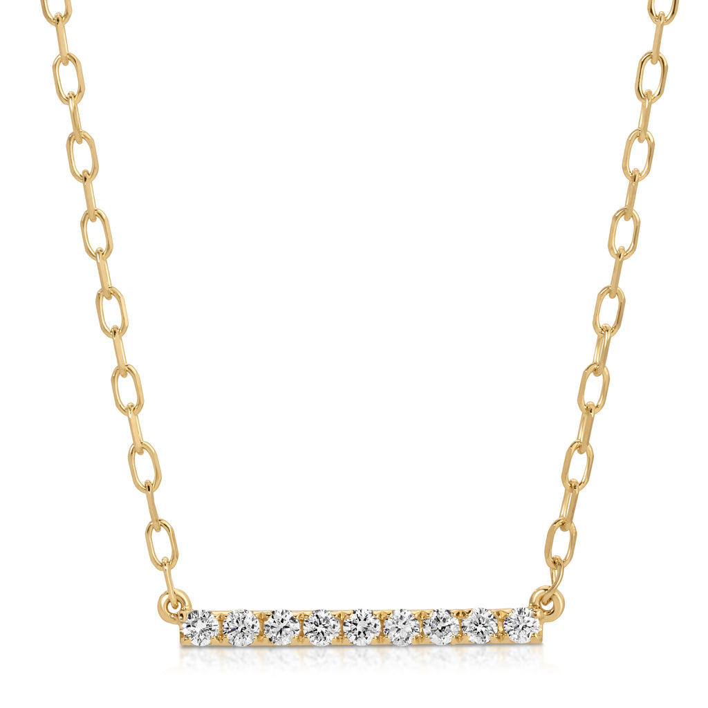 Gold necklace with a bar pendant featuring diamonds on a white background