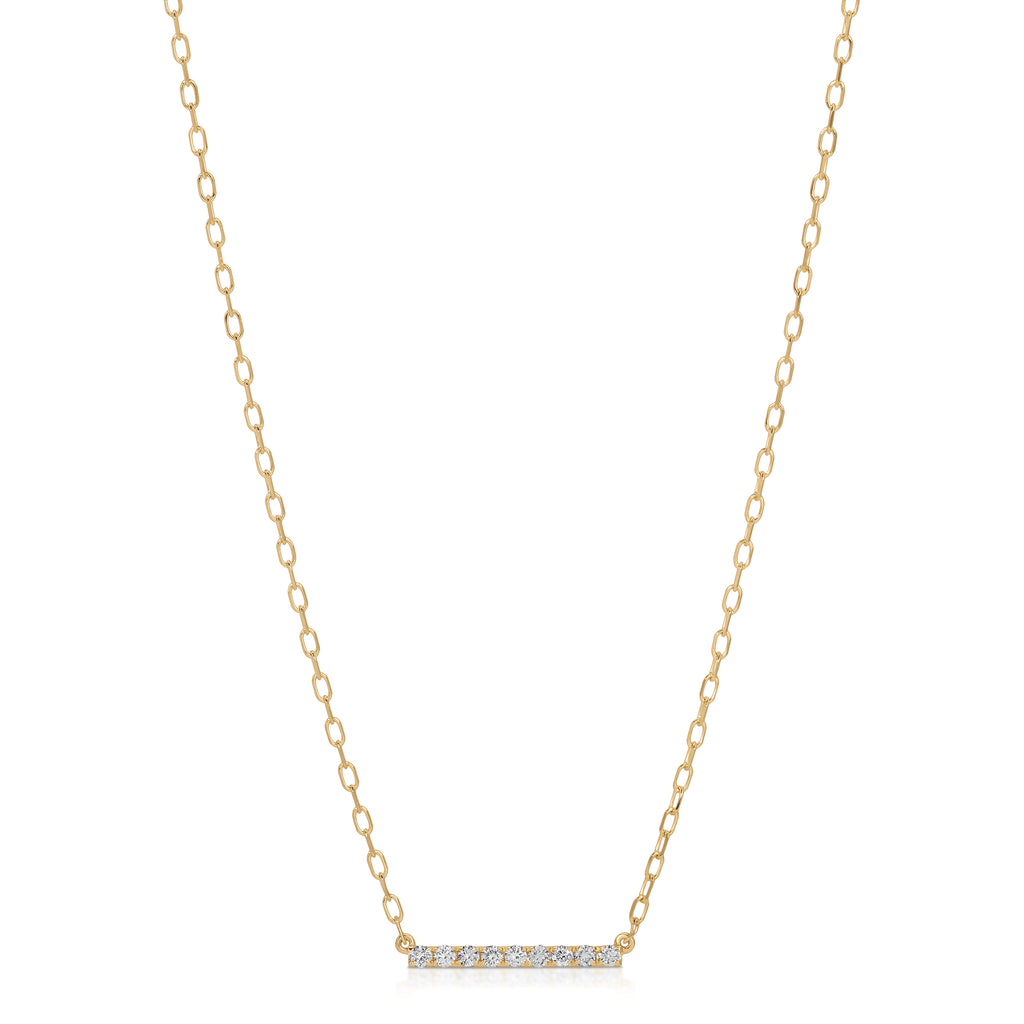 Gold necklace with a bar pendant on a white background
