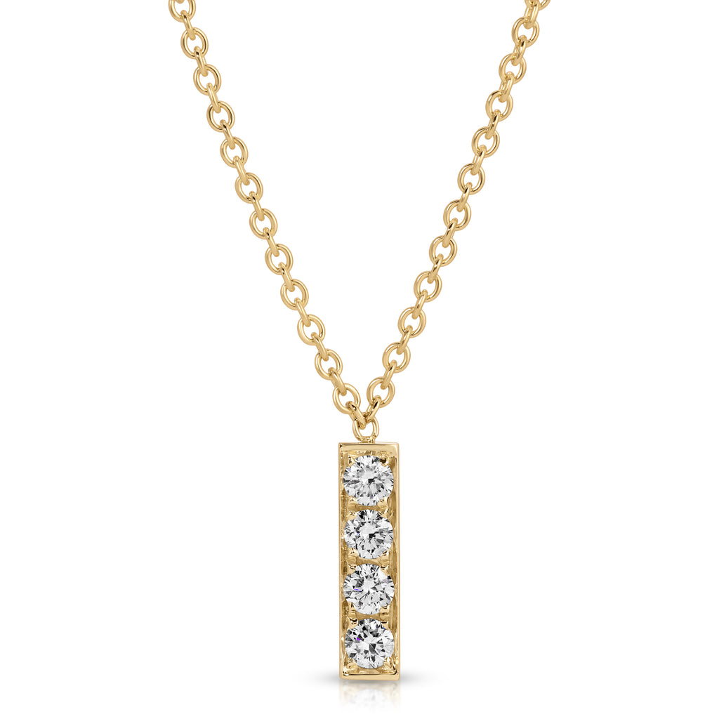 Gold necklace with a bar pendant featuring three diamonds on a white background
