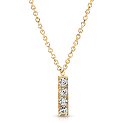 Gold necklace with a bar pendant featuring three diamonds on a white background