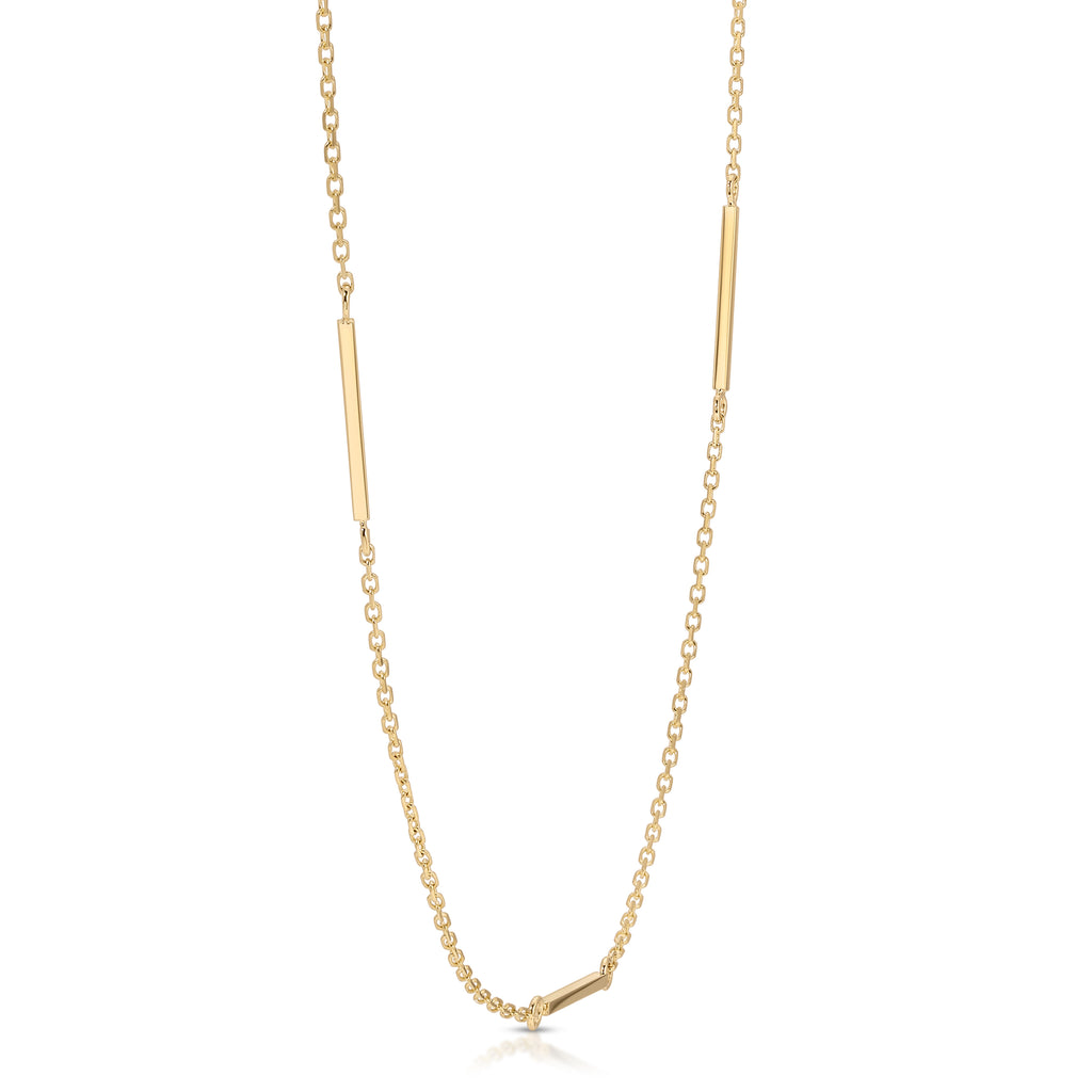 Gold necklace with bar pendants on a white background