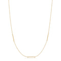 Gold necklace with a bar pendant on a white background
