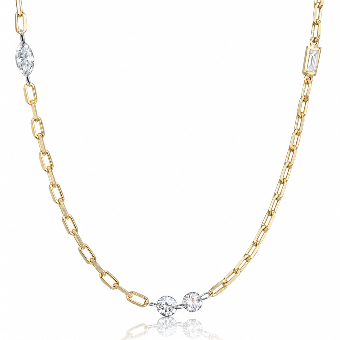 A delicate gold chain necklace featuring three small round-cut clear gemstones at the center, with additional clear stones set at intervals along the chain, displayed on a clean white background with a soft reflection below.