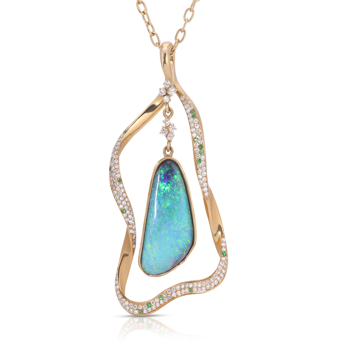 A gold pendant necklace featuring a teardrop-shaped iridescent blue-green opal stone, surrounded by an abstract wavy gold frame paved with small clear stones and accented with green stones, shown on a white background.