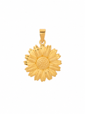 A yellow gold daisy flower pendant with a textured center and small dark oxidized details on the petals, shown against a plain white background.
