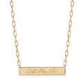 A gold bar necklace with a rectangular pendant engraved with the French phrase 'C'est Pour Vous', suspended from a gold paperclip chain on a white background.