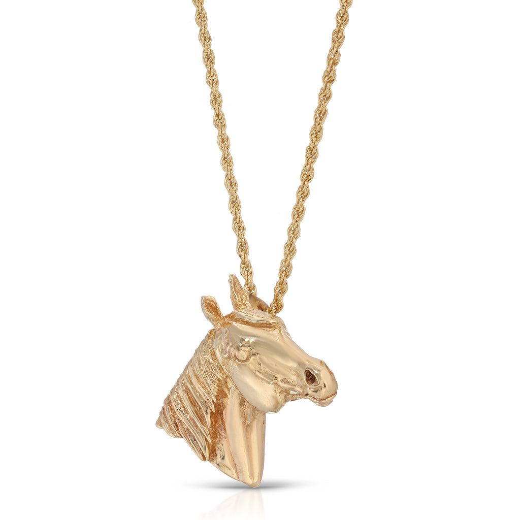 Gold horse head pendant on a chain against a white background
