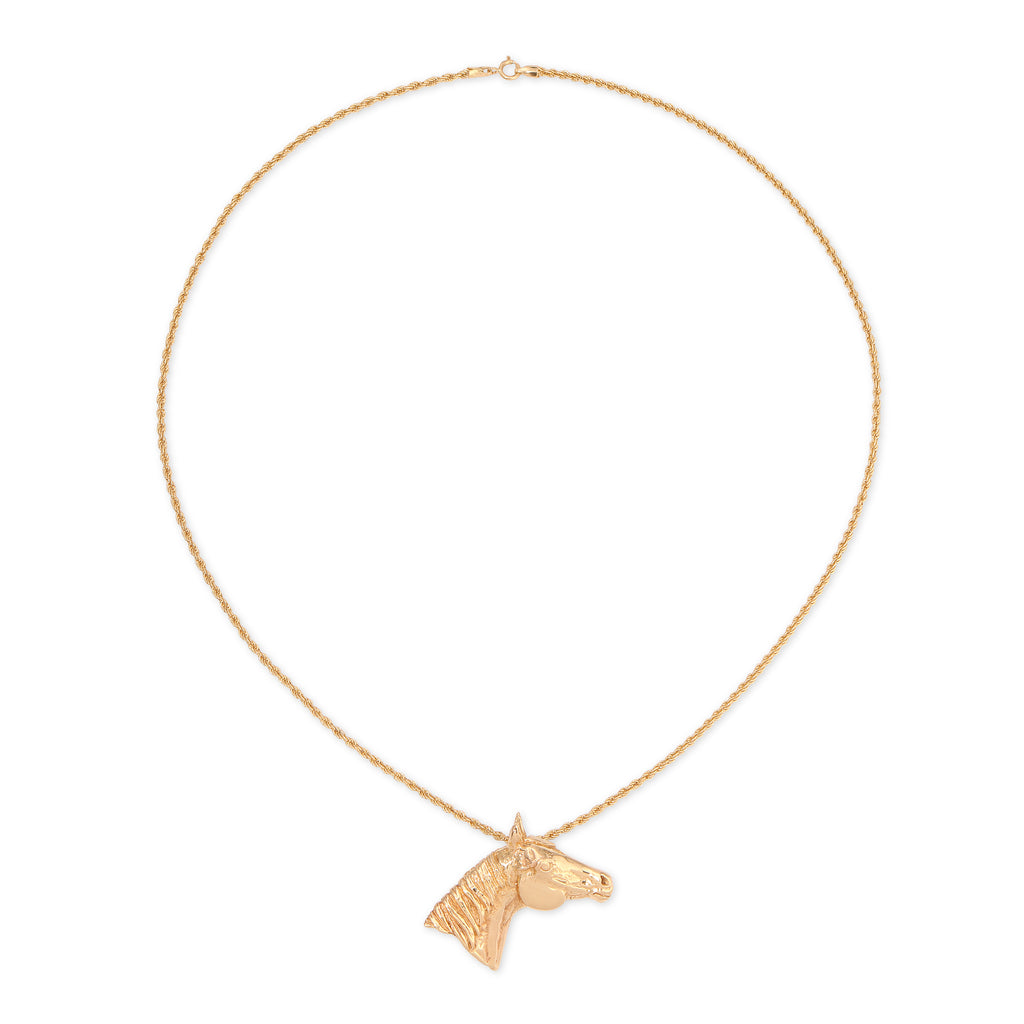 Gold horse head necklace on a white background