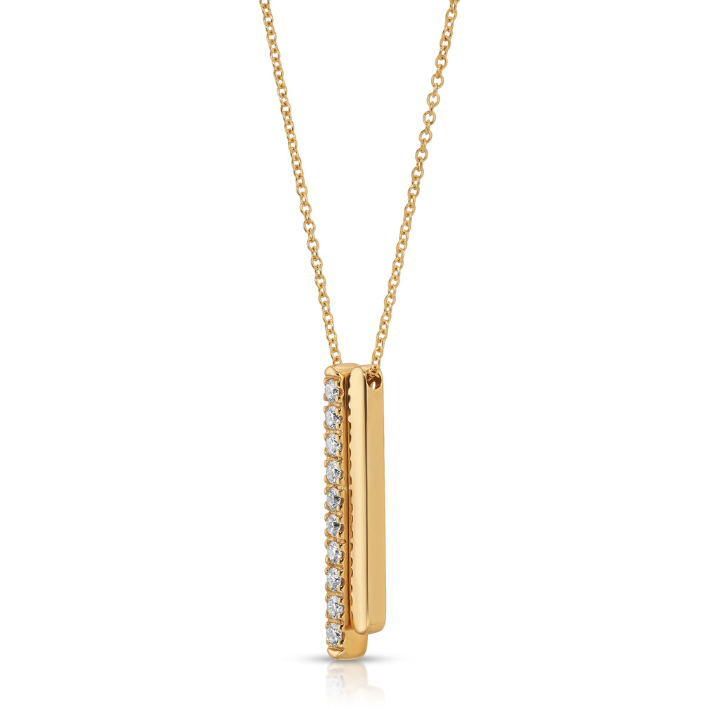 Gold necklace with a vertical bar pendant on a white background