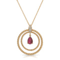 Gold necklace with a red gemstone pendant on a white background