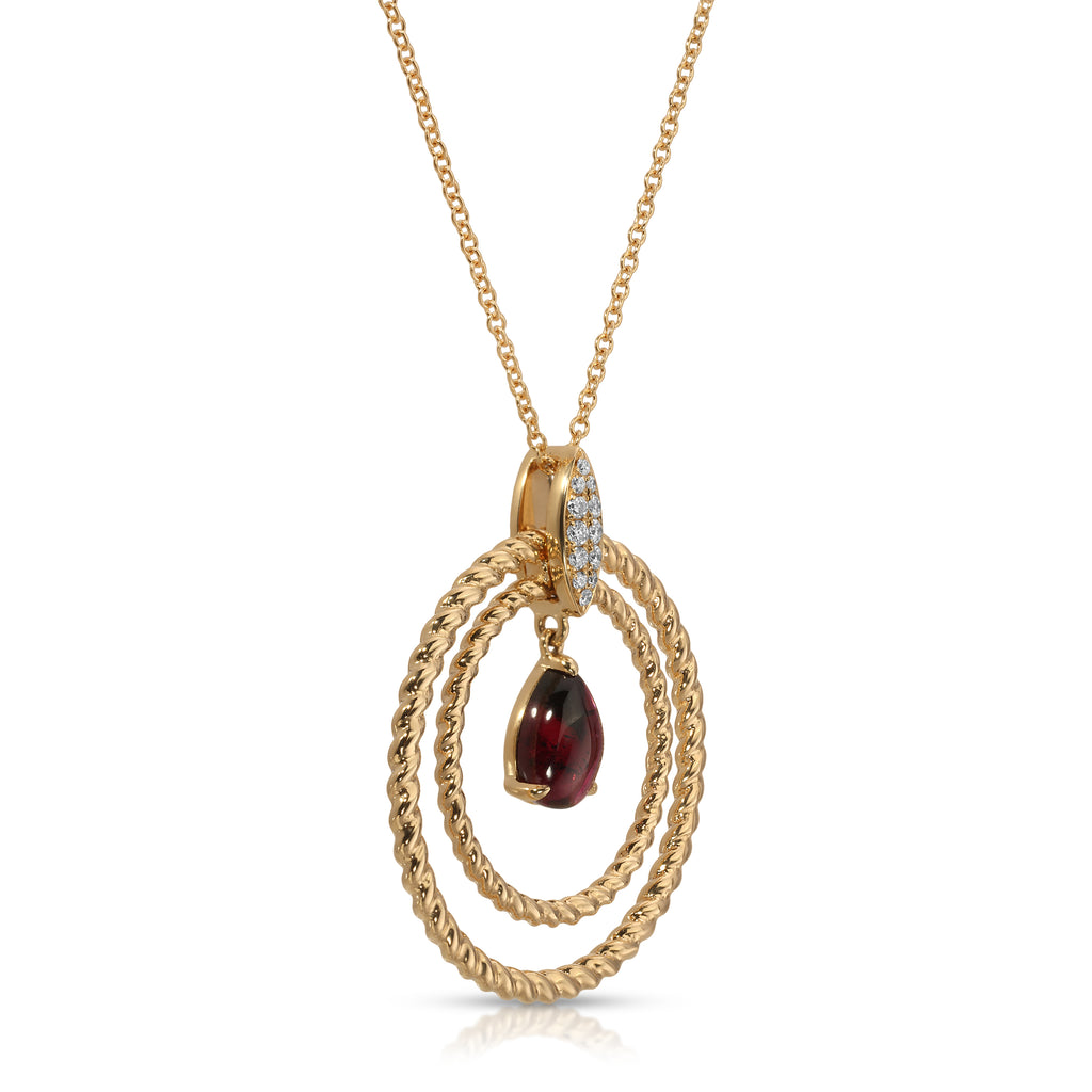 Gold necklace with a pendant featuring a red gemstone on a white background
