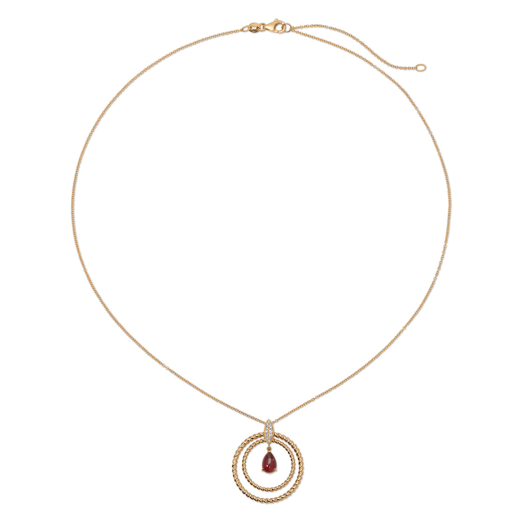 Gold necklace with a circular pendant featuring a red gemstone on a white background