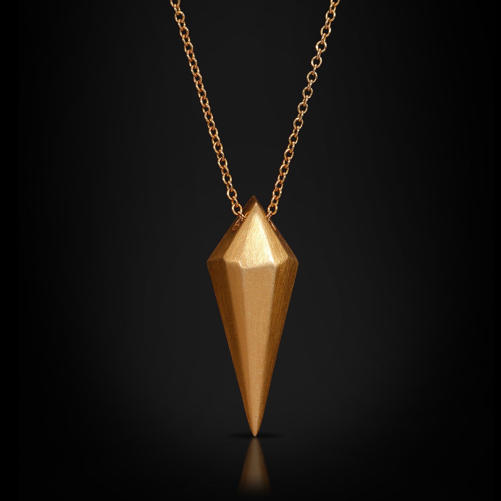 Gold pendant necklace on a black background
