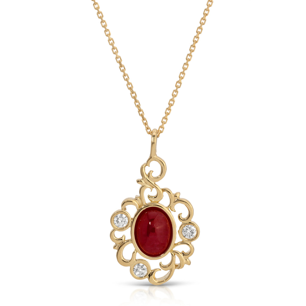 Gold necklace with a red gemstone pendant on a white background