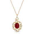 Gold necklace with a red gemstone pendant on a white background