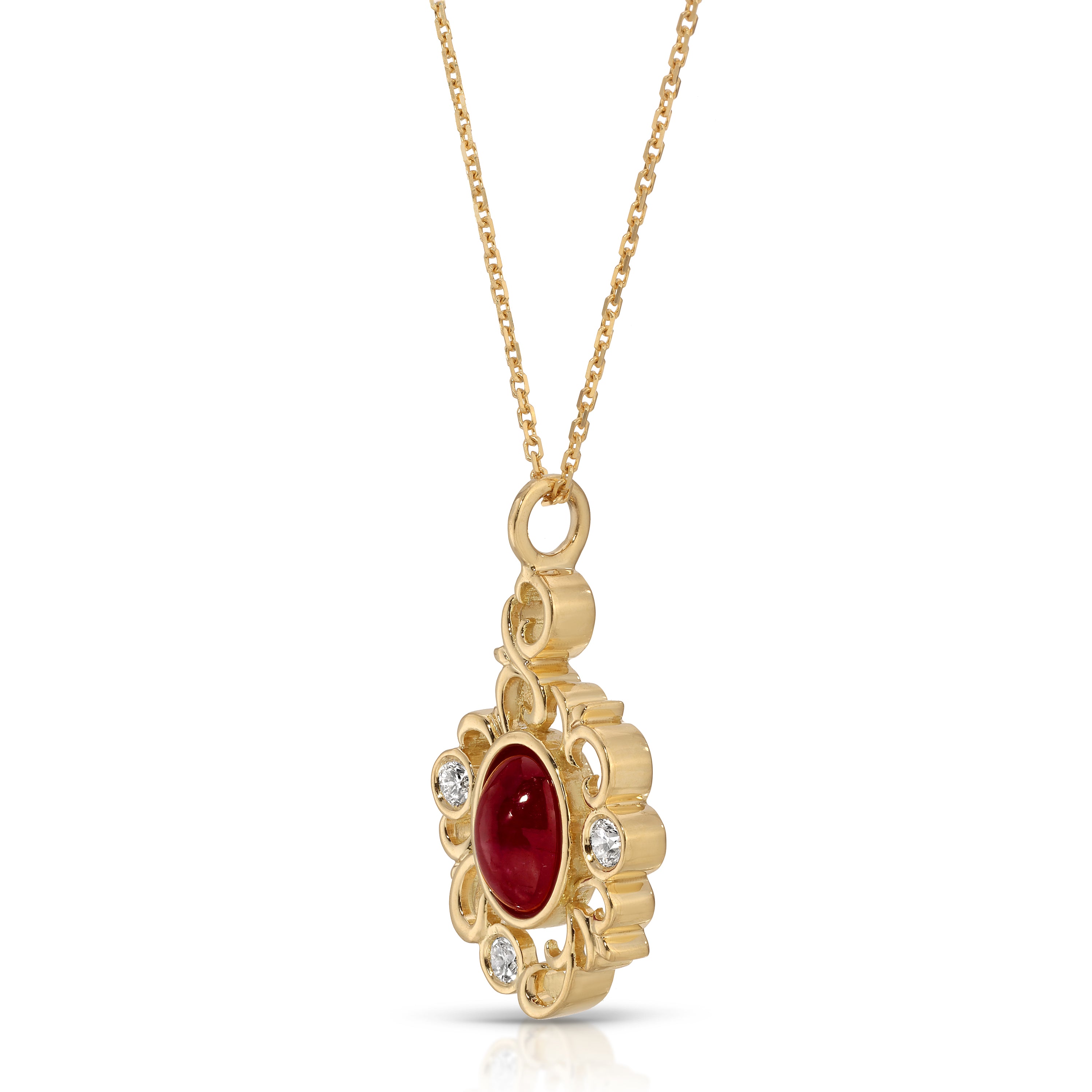 Gold pendant with a red gemstone on a white background