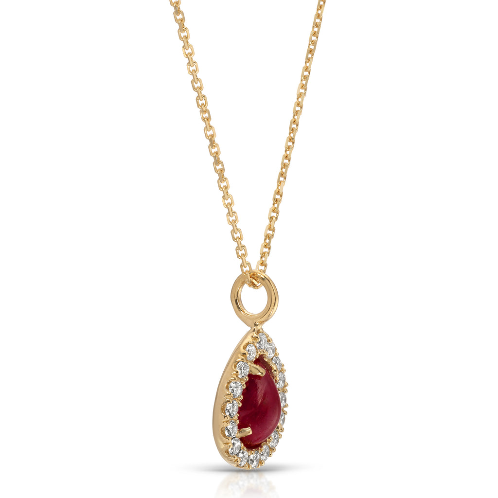Gold necklace with a red gemstone and diamond accents on a white background