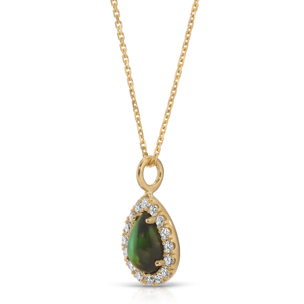 Gold necklace with a green teardrop pendant on a white background