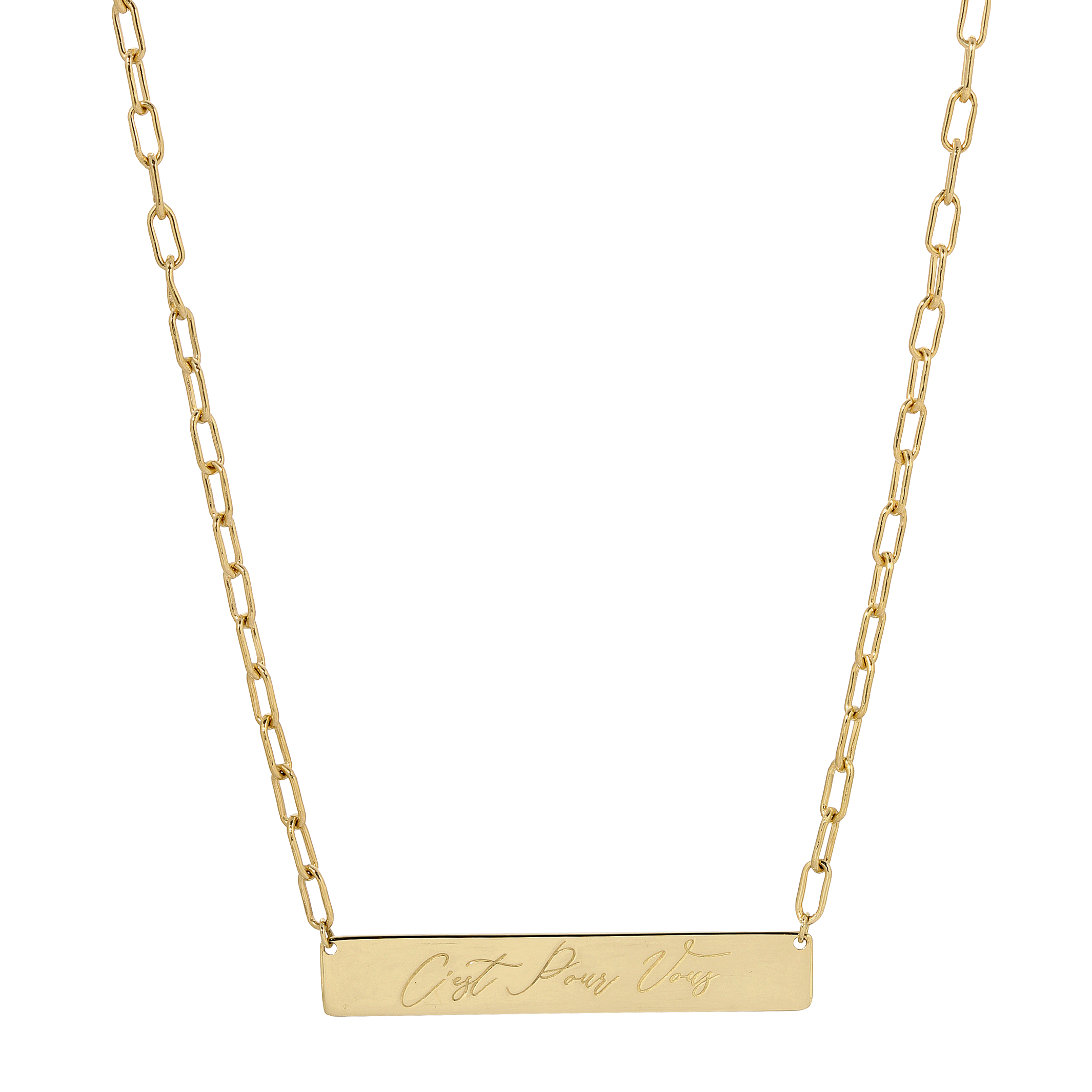 A gold bar necklace with a rectangular pendant engraved with the words 'Just Like That' in cursive script, suspended from a paperclip chain on a white background.