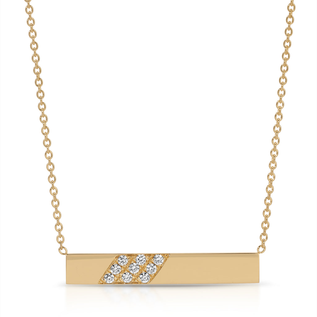 Gold necklace with a bar pendant featuring diamond-like stones on a white background