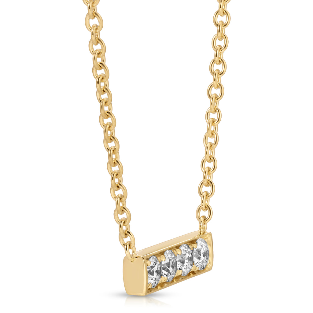 Gold necklace with a diamond bar pendant on a white background