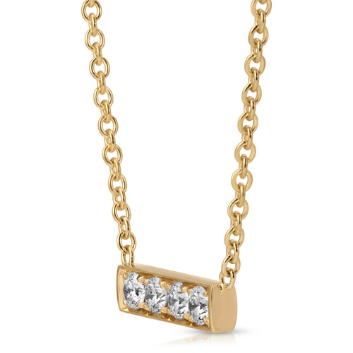 Gold necklace with a bar pendant featuring three diamonds on a white background