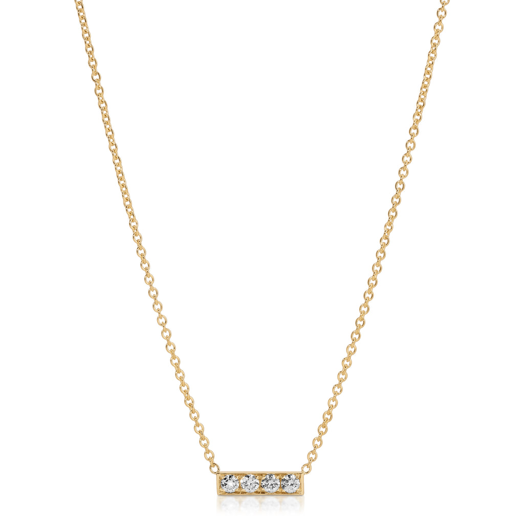 Gold necklace with a bar pendant featuring three diamonds on a white background