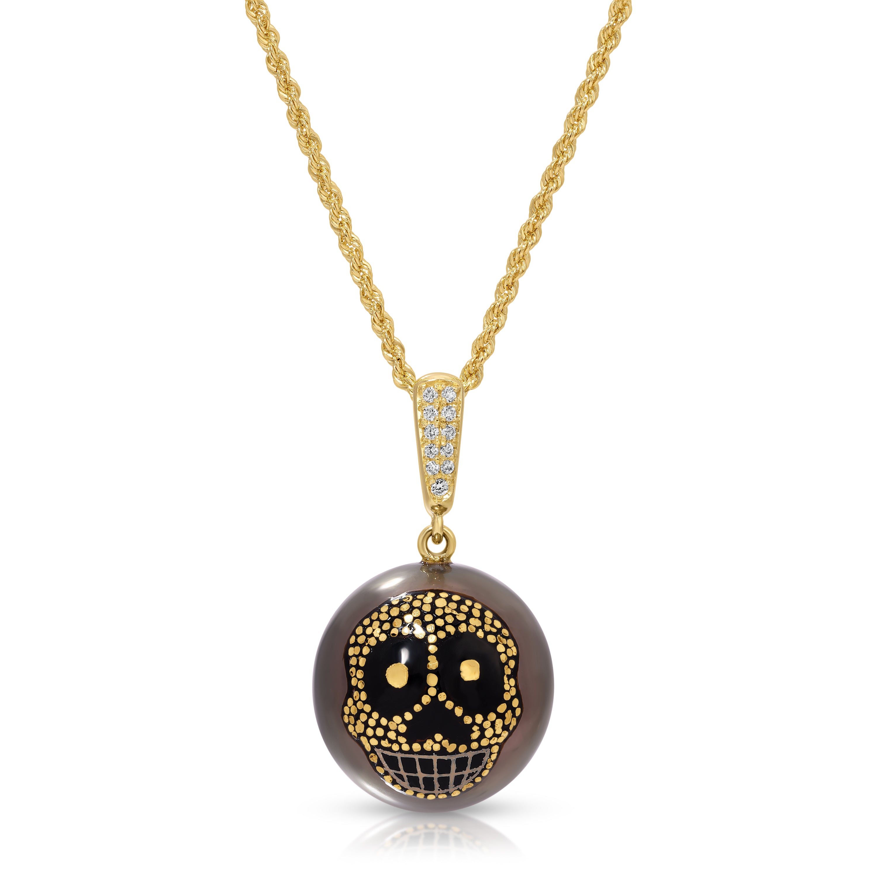 A gold chain necklace with a round pendant featuring a black and gold sugar skull design on a smoky brown background, set against a plain white background.